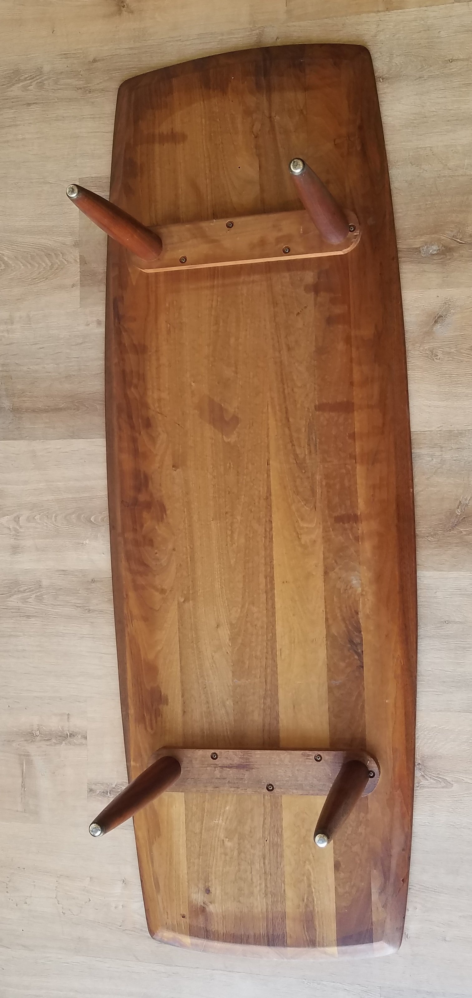 Underside view of Vintage American Mid-Century Modern Prelude Walnut Surfboard Coffee Table in Seattle, Washington.