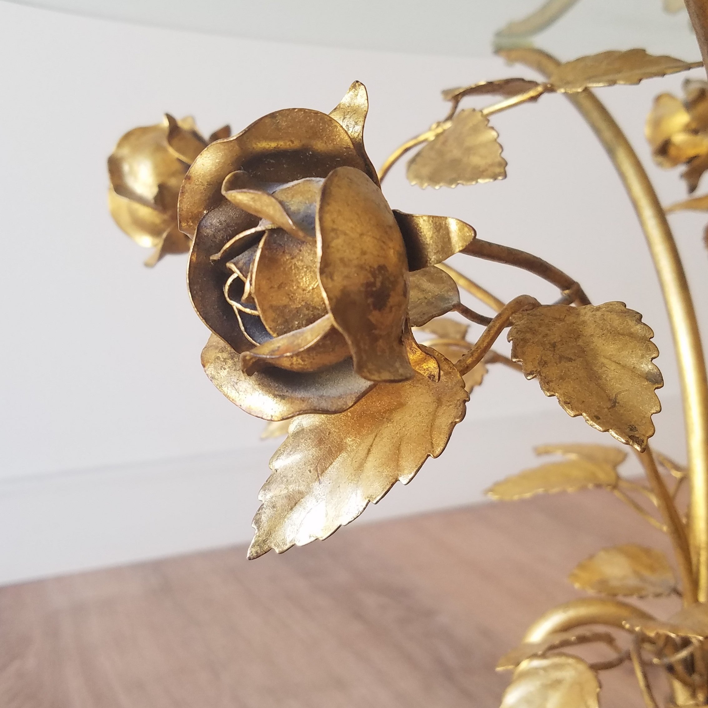 Detail View of a Hollywood Regency Side Table with Brass Roses and a glass top. Find this at SPARKLEBARN, a vintage Mid-Century Modern furniture store in Ballard.
