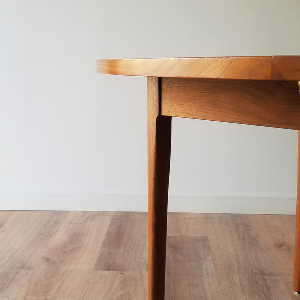 Detail view of a Round Walnut Mid-Century Modern Dining Table designed by Kipp Stewart for Drexel. See this table and other great restored vintage furniture at SPARKLEBARN in Ballard.
