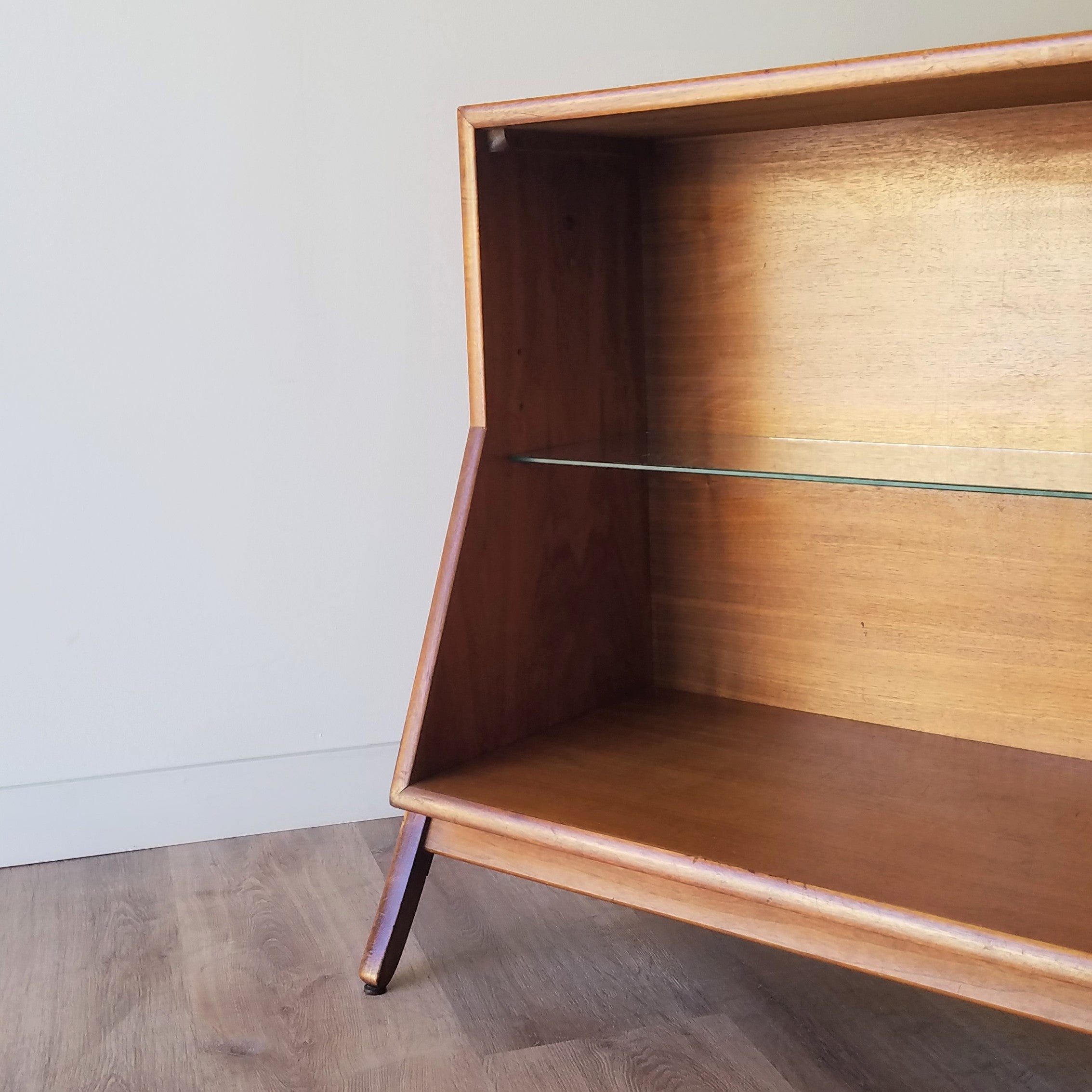 Detail view of  an American Mid-Century Modern walnut bookcase designed by Kipp Stewart for Drexel. This bookcase and other great restored vintage furniture can be found at SPARKLEBARN in Seattle, WA.