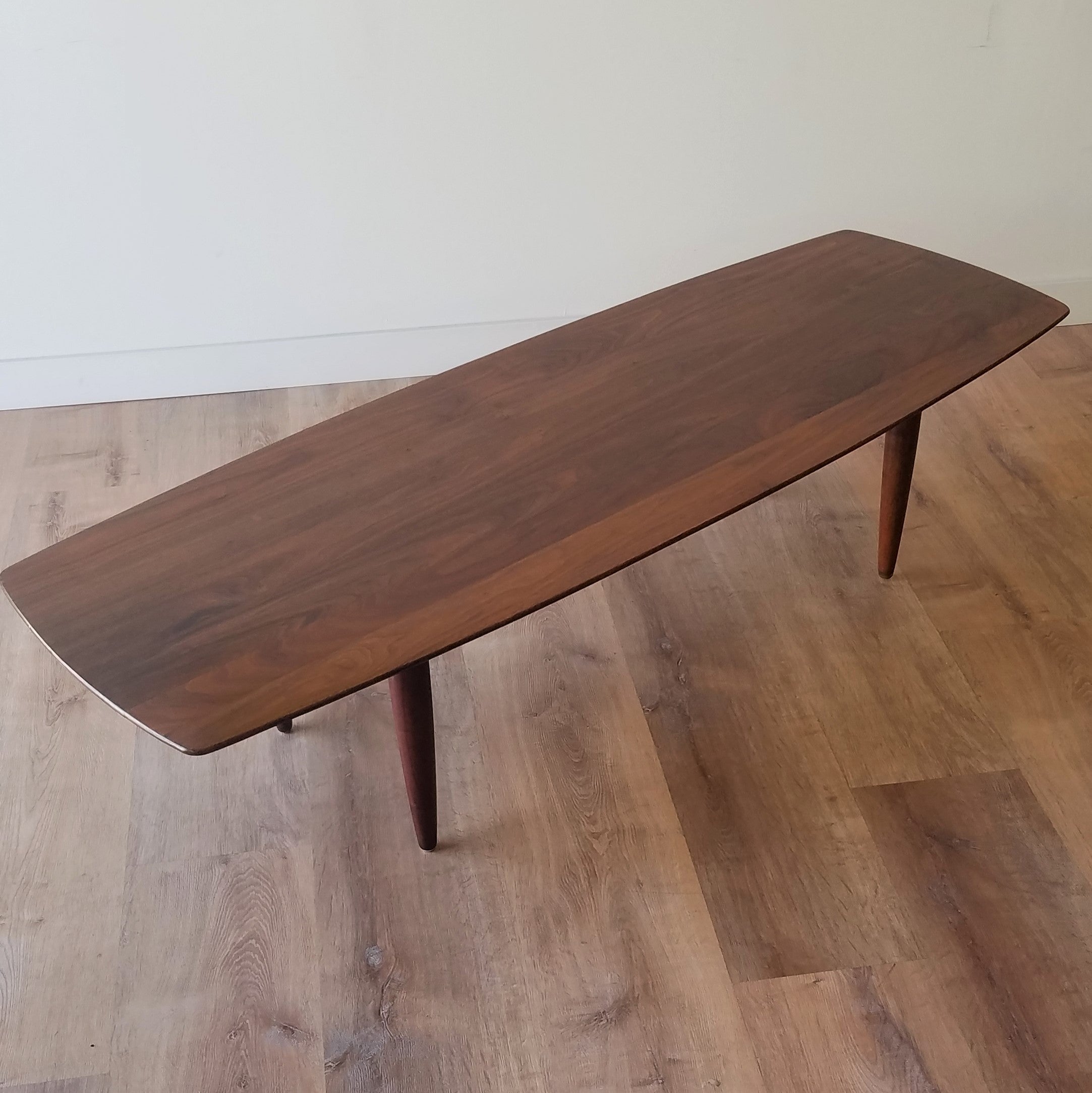 Front Quarter view of American Mid-Century Modern Prelude Walnut Surfboard Coffee Table in Seattle, Washington.