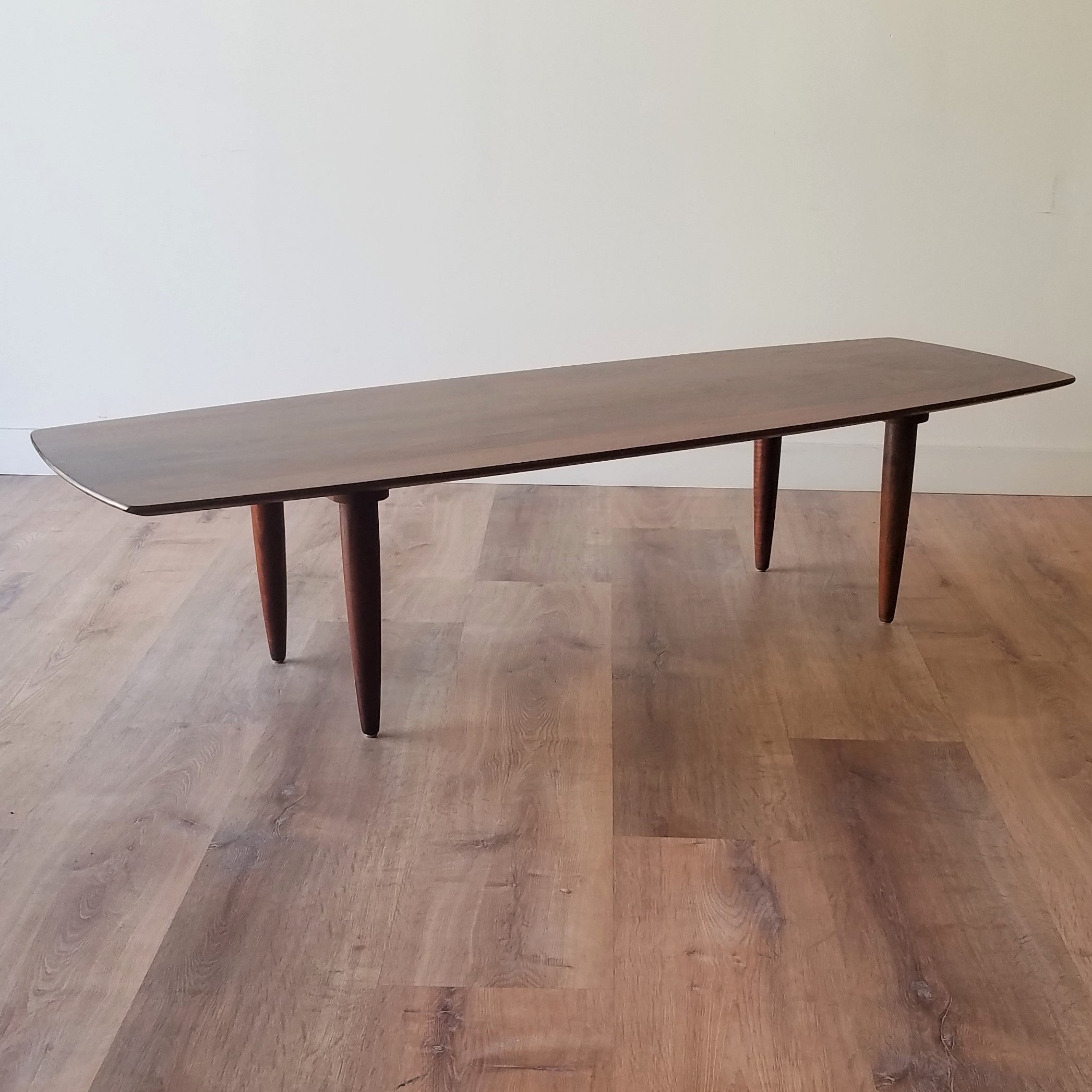 Side Angle view of American Mid-Century Modern Prelude Walnut Surfboard Coffee Table in Seattle, Washington.