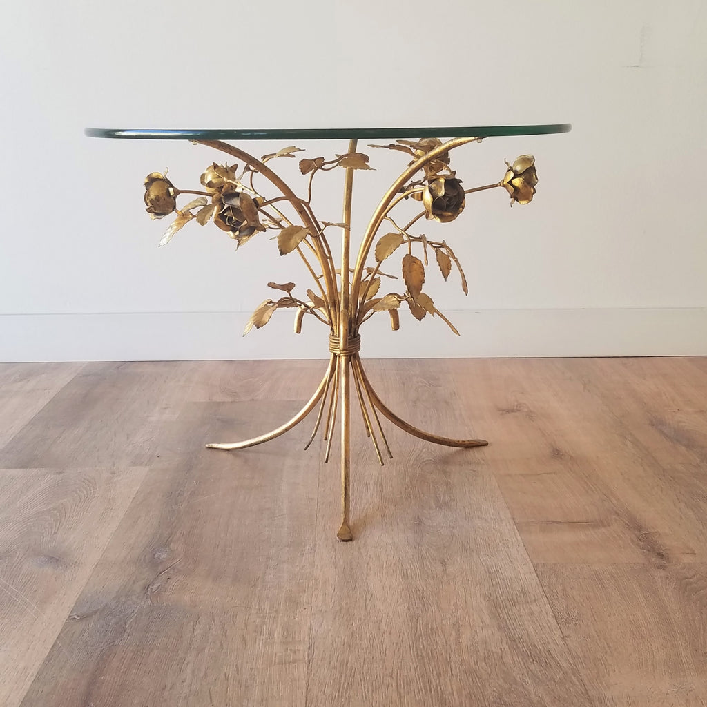 A side view of a Hollywood Regency Side Table with Brass Scupltued Roses and a glass top. This Mid-Century Modern piece of furniture and other vintage furniture can be found at SPARKLEBARN in Seattle.