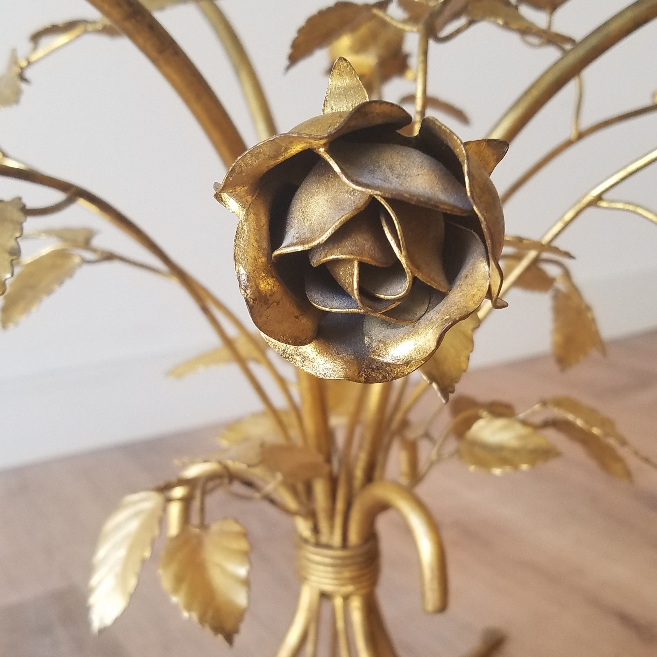 Detail view of a Hollywood Regency Side Table with Brass Roses and a glass top. This retro style and other vintage furniture can be found at SPARKLEBARN in Ballard.