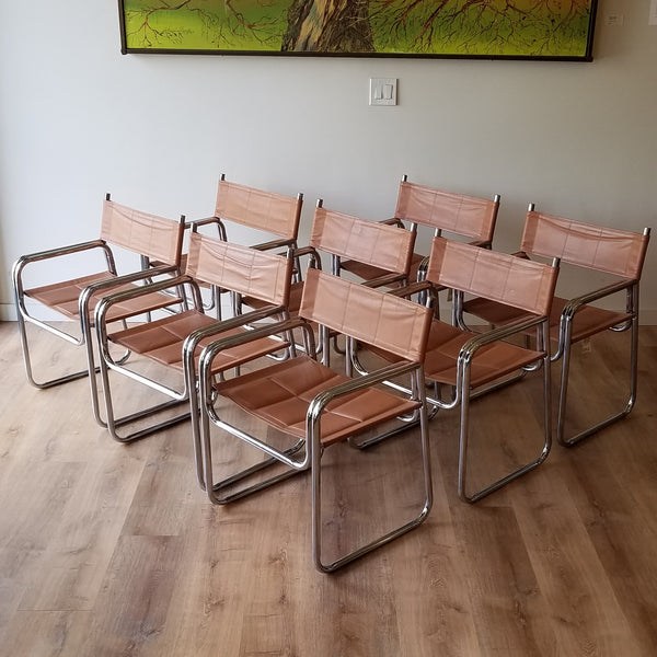 Quarter View of a Set of eight MCM Chrome Dining Chairs with Brown Vinyl Seat and Backrests. Find them at SPARKLEBARN in Ballard.