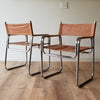 Front and Back Quarter View of a Pair of Mid-Century Modern Chrome Dining Chairs with Brown Vinyl Seat and Backrests. Find them at SPARKLEBARN in Ballard.