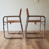Side View of a pair of Mid-Century Modern Chrome Dining Chairs with Brown Vinyl Seat and Backrests. Find them at SPARKLEBARN in Seattle..