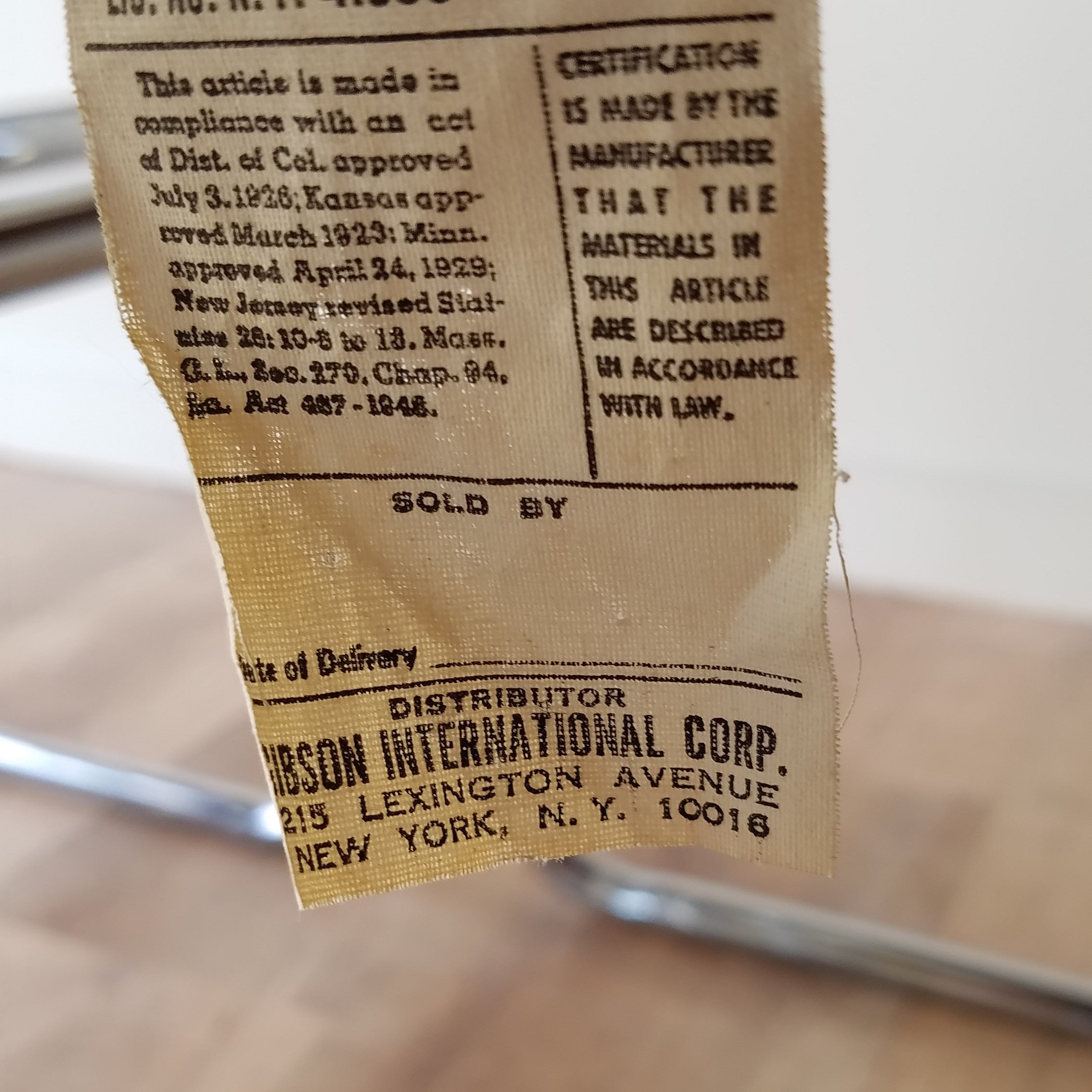 Tag of a MCM Chrome Dining Chair distributed by Gibson International Corp with Brown Vinyl Seat and Backrests. Find them at SPARKLEBARN in Seattle,WA..